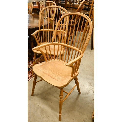 73 - A set of six light elm and ash spindle back Windsor chairs with moulded seats on turned legs with st... 