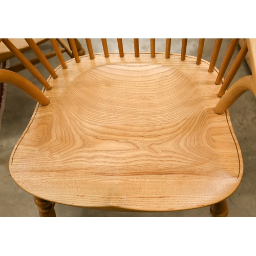 73 - A set of six light elm and ash spindle back Windsor chairs with moulded seats on turned legs with st... 