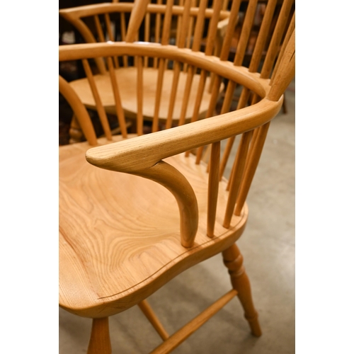 73 - A set of six light elm and ash spindle back Windsor chairs with moulded seats on turned legs with st... 