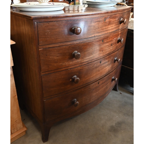 84 - A 19th century mahogany bowfront chest of four long graduating drawers with turned handles and splay... 