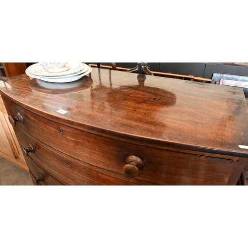 84 - A 19th century mahogany bowfront chest of four long graduating drawers with turned handles and splay... 