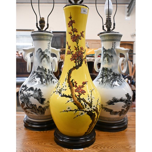 441 - A pair of Asian ceramic table lamps painted with landscapes, 48 cm high, to/w a yellow glazed lamp p... 