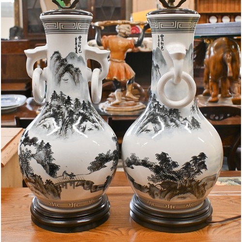 441 - A pair of Asian ceramic table lamps painted with landscapes, 48 cm high, to/w a yellow glazed lamp p... 