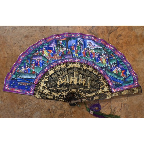 457 - An antique Cantonese fan with gilded black lacquer sticks and painted paper leaf decorated on both s... 