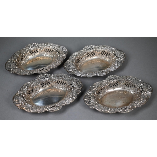 124 - A late Victorian cased set of four embossed, chased and pierced silver bonbon dishes, Henry Matthews... 