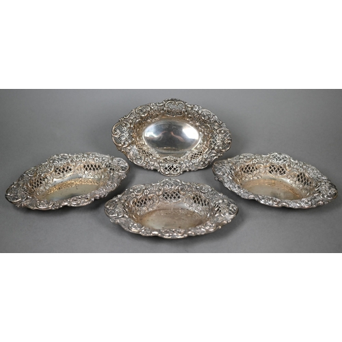 124 - A late Victorian cased set of four embossed, chased and pierced silver bonbon dishes, Henry Matthews... 