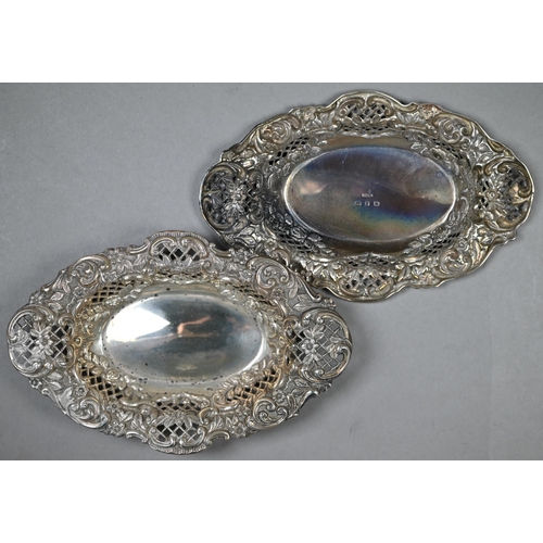 124 - A late Victorian cased set of four embossed, chased and pierced silver bonbon dishes, Henry Matthews... 