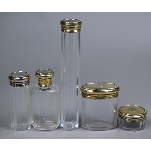 130 - An Asprey puce Morocco leather dressing case, fitted with five cut glass toilet jars - four with sil... 