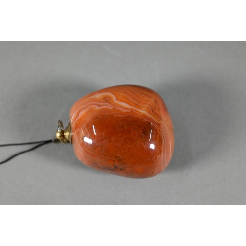 376 - A polished carnelian agate large pendant, 5.5 cm to/w a carved agate frog, 5.5 cm, a jadeite Buddha ... 