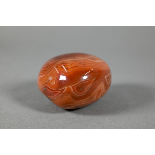 376 - A polished carnelian agate large pendant, 5.5 cm to/w a carved agate frog, 5.5 cm, a jadeite Buddha ... 