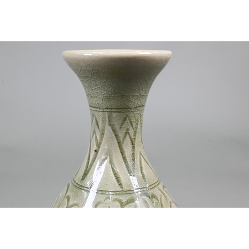 377 - A Chinese Yazhou Northern Celadon vase with incised floral and foliate decoration under the pale oli... 