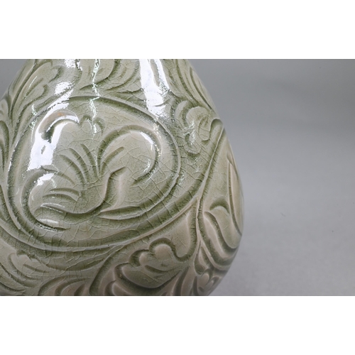 377 - A Chinese Yazhou Northern Celadon vase with incised floral and foliate decoration under the pale oli... 