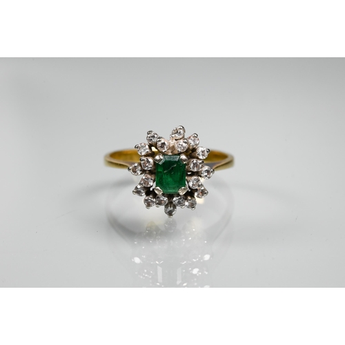 334 - An emerald and diamond cluster ring, the central rectangular emerald surrounded by twenty small diam... 