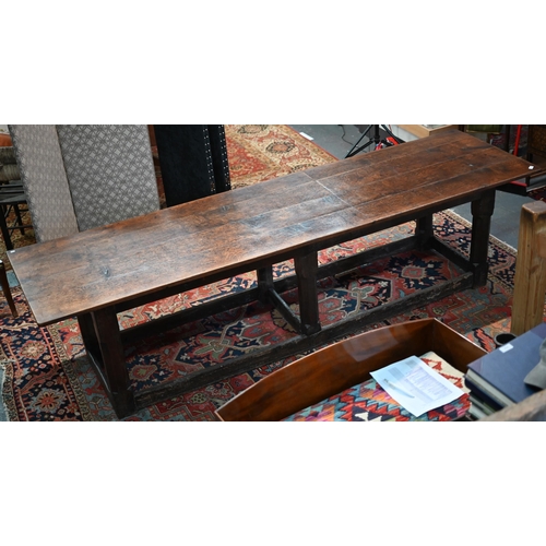 756 - A 17th century oak refectory table, the four plank top raised on a joined six moulded and chamfered ... 