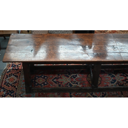756 - A 17th century oak refectory table, the four plank top raised on a joined six moulded and chamfered ... 
