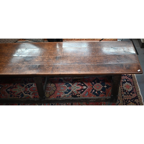 756 - A 17th century oak refectory table, the four plank top raised on a joined six moulded and chamfered ... 
