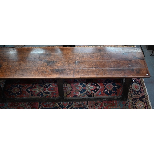 756 - A 17th century oak refectory table, the four plank top raised on a joined six moulded and chamfered ... 