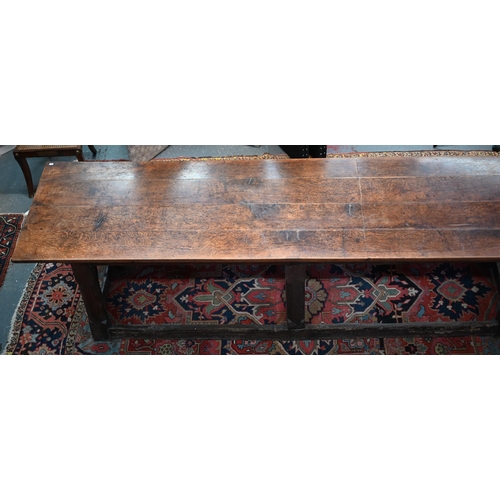 756 - A 17th century oak refectory table, the four plank top raised on a joined six moulded and chamfered ... 