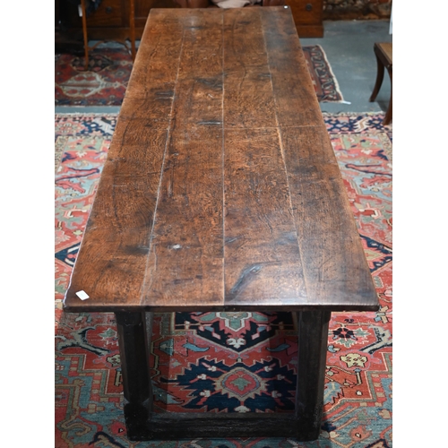 756 - A 17th century oak refectory table, the four plank top raised on a joined six moulded and chamfered ... 