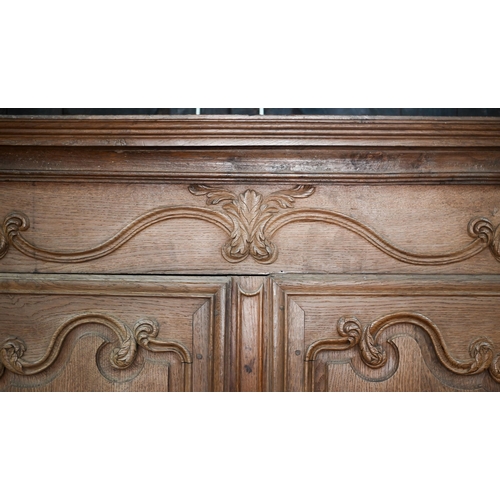 757 - An 18th/19th century French bleached oak armoire, the moulded cornice over a pair of moulded panelle... 