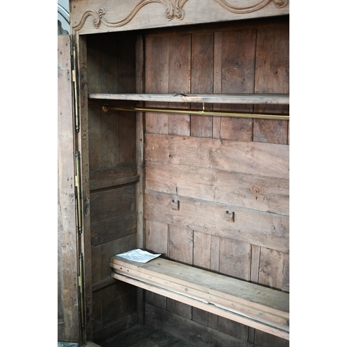 757 - An 18th/19th century French bleached oak armoire, the moulded cornice over a pair of moulded panelle... 