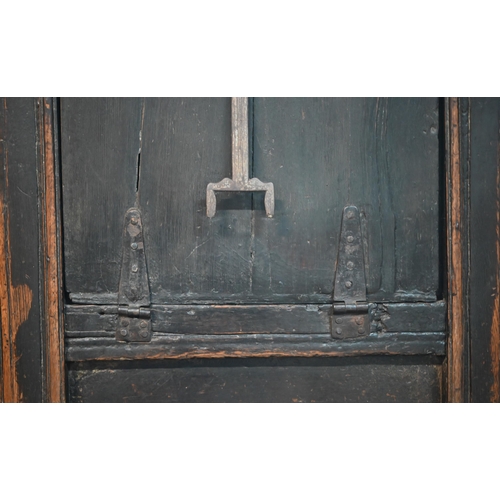 692 - A 17th century Welsh oak box settle, the crest rail with lunette carved decoration over further carv... 