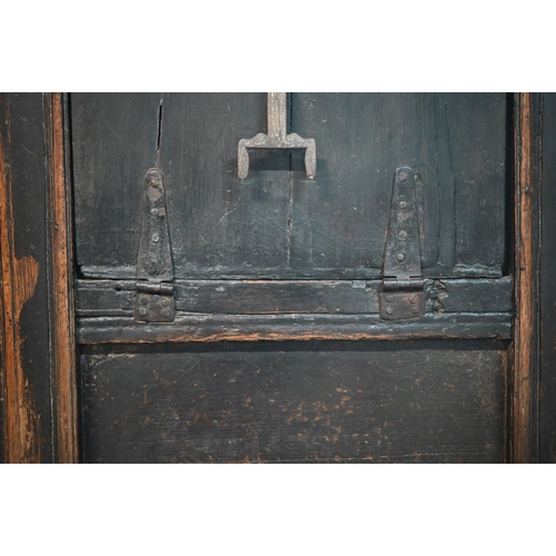 692 - A 17th century Welsh oak box settle, the crest rail with lunette carved decoration over further carv... 