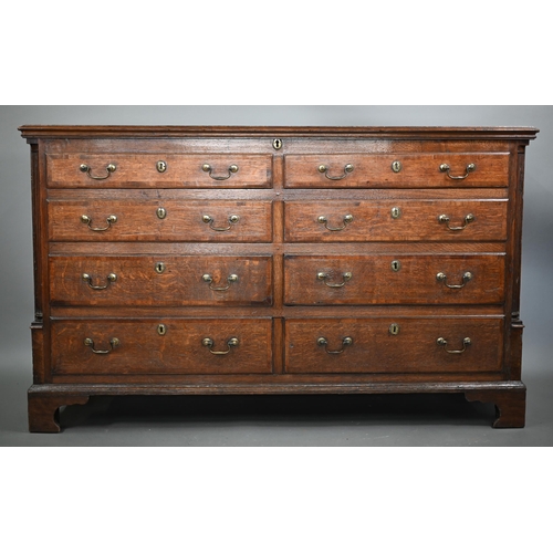 696 - An 18th century Lancashire oak mule chest, the twin plank hinged top over four dummy drawer fronts a... 