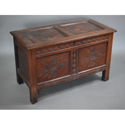 668 - A late 17th century carved joint oak coffer, the staple hinged top over two floral carved panels, on... 