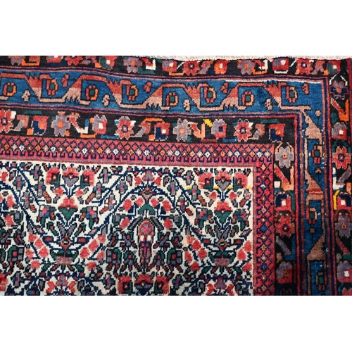 606 - A contemporary North West Persian Afshar carpet, the repeating floral design on camel ground, 250 cm... 