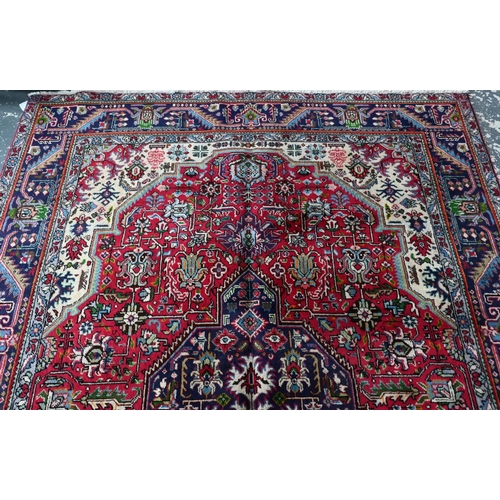 610 - A North West Persian Tabriz carpet, the coral-red ground centred by a medallion, 305 cm x 205 cm