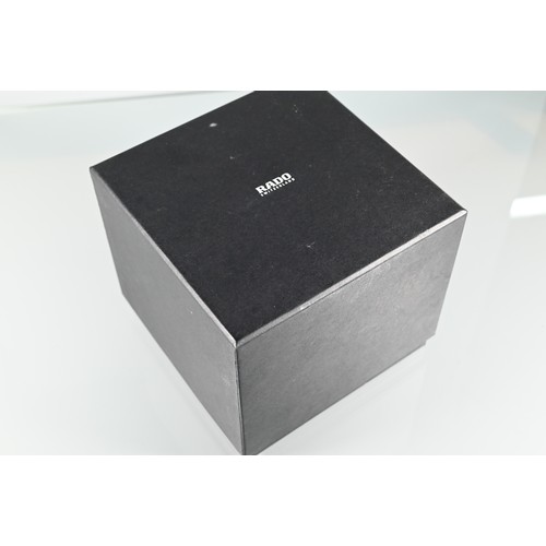 178 - Rado, a white cased lady's wristwatch, quartz movement, on deployment bracelet, with box, manual and... 