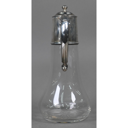 107 - A glass claret jug with star-cut base and silver collar, hinged cover and scroll handle, William Hut... 