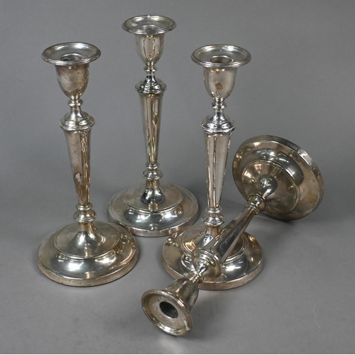 123 - A set of four loaded silver baluster candlesticks with detachable grease-pans, M C Hersey & Son ... 