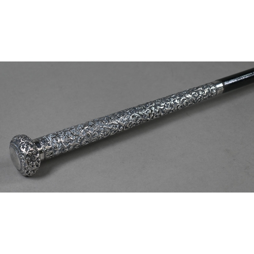 131 - An Indian ebonised staff with embossed and chased white metal pommel and long collar, 146cm long