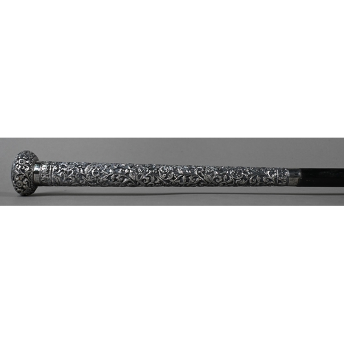 131 - An Indian ebonised staff with embossed and chased white metal pommel and long collar, 146cm long