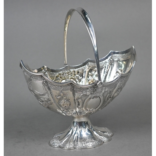 138 - A Victorian silver bonbon basket of lobed navette form with swing handle and embossed and chased dec... 