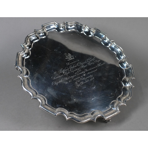 140 - A large silver salver with shaped and moulded rim, on three scroll feet, Thomas Bradbury & Sons ... 