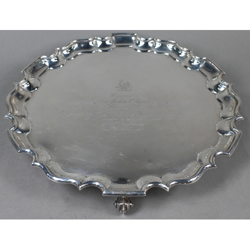 140 - A large silver salver with shaped and moulded rim, on three scroll feet, Thomas Bradbury & Sons ... 