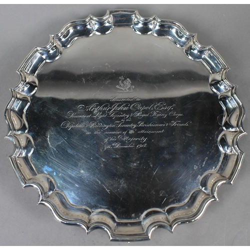 140 - A large silver salver with shaped and moulded rim, on three scroll feet, Thomas Bradbury & Sons ... 