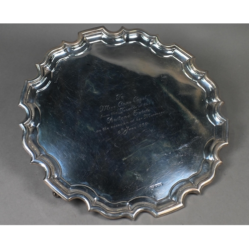 141 - A large silver salver with shaped and moulded rim, on three scroll feet, Lee & Wigfull, Sheffiel... 