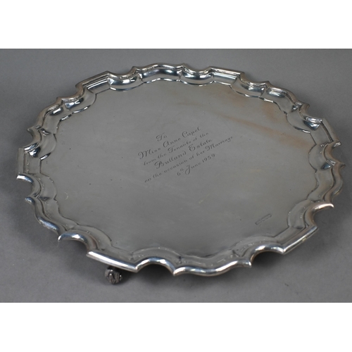 141 - A large silver salver with shaped and moulded rim, on three scroll feet, Lee & Wigfull, Sheffiel... 