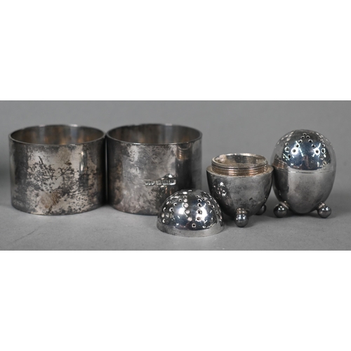 142 - Two heavy quality silver napkin rings, London 1945, to/w a pair of Victorian ovoid pepperettes, Shef... 