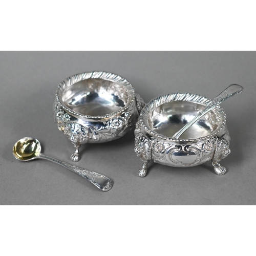 146 - A pair of Victorian silver circular salts with gadrooned rims, floral chased decoration and lion mas... 