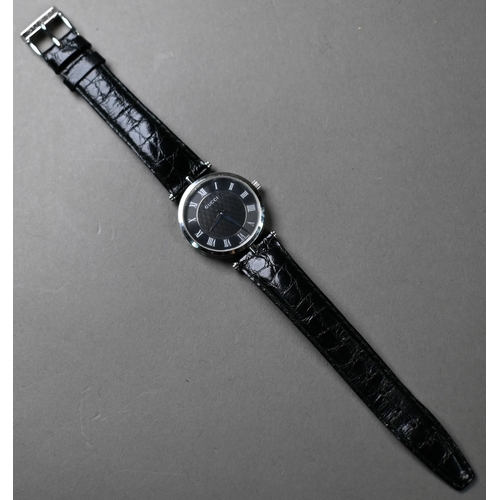 192 - A Gucci GQ2040M stainless steel gents wrist watch, black dial, on Gucci branded black textured leath... 