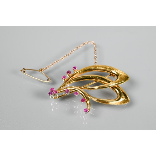 208 - An 18ct yellow gold brooch in the form of a double stylised scroll, set with ten small round rubies ... 