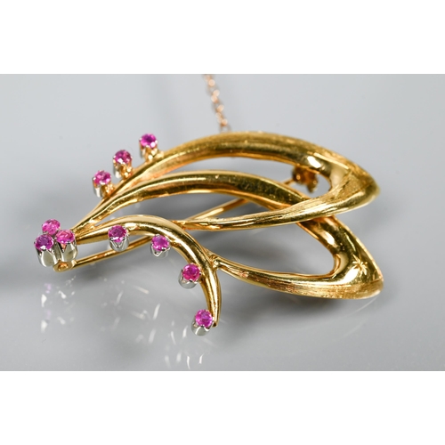 208 - An 18ct yellow gold brooch in the form of a double stylised scroll, set with ten small round rubies ... 
