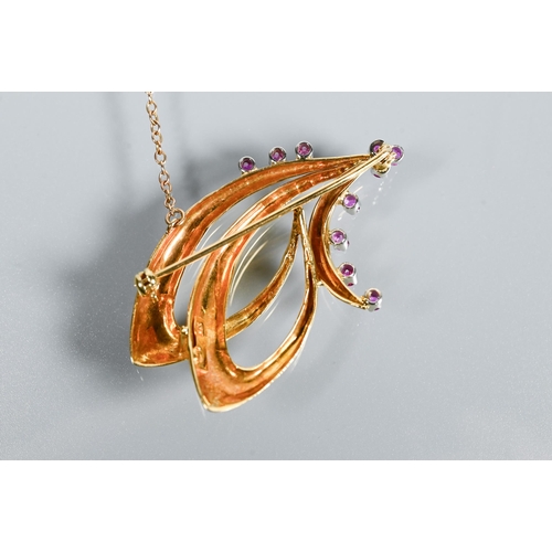 208 - An 18ct yellow gold brooch in the form of a double stylised scroll, set with ten small round rubies ... 
