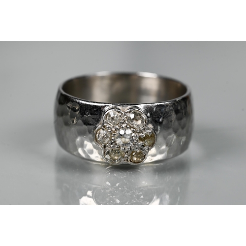 216 - A contemporary 9ct white gold wide band with hammered finish, set with seven-stone diamond cluster, ... 