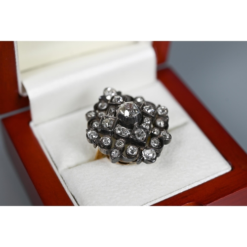 217 - An antique diamond cluster ring, the central old cut diamond sourrounded by a cluster of thirty-two ... 